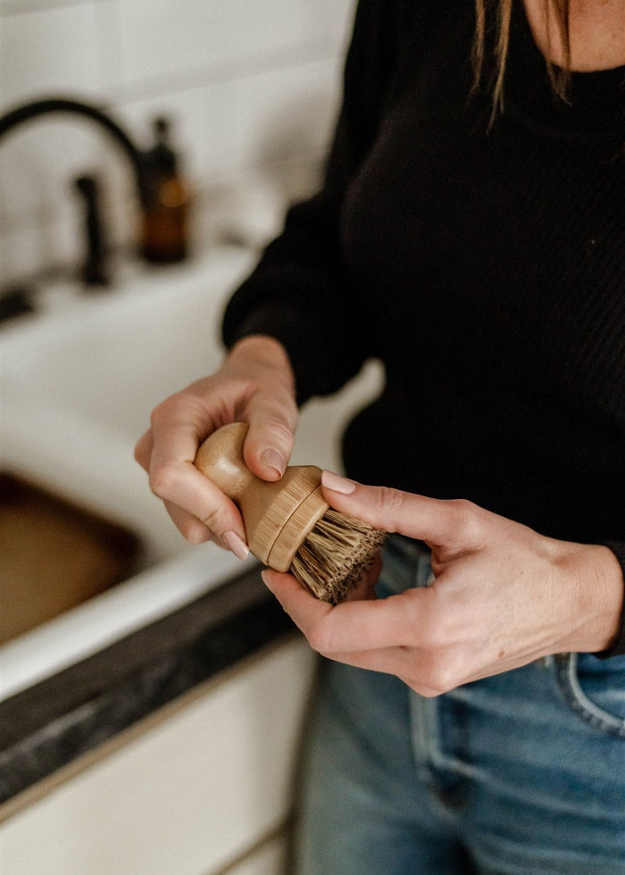 woman unscrewing pot brush head