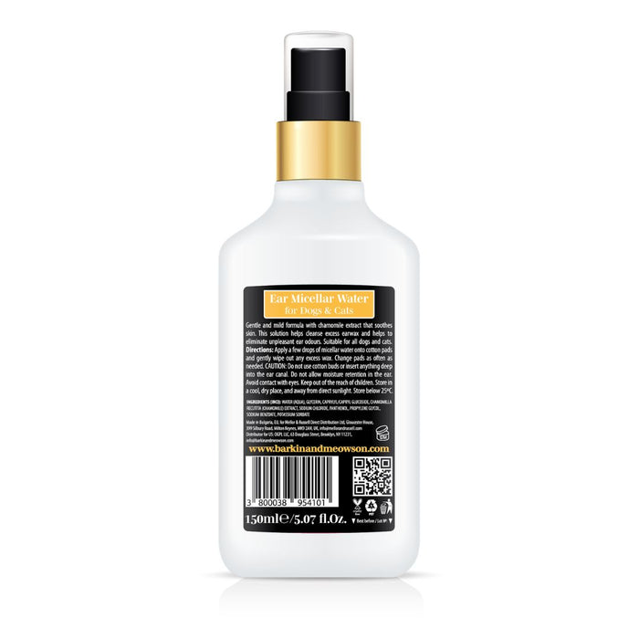 White spray bottle with gold cap on a white background