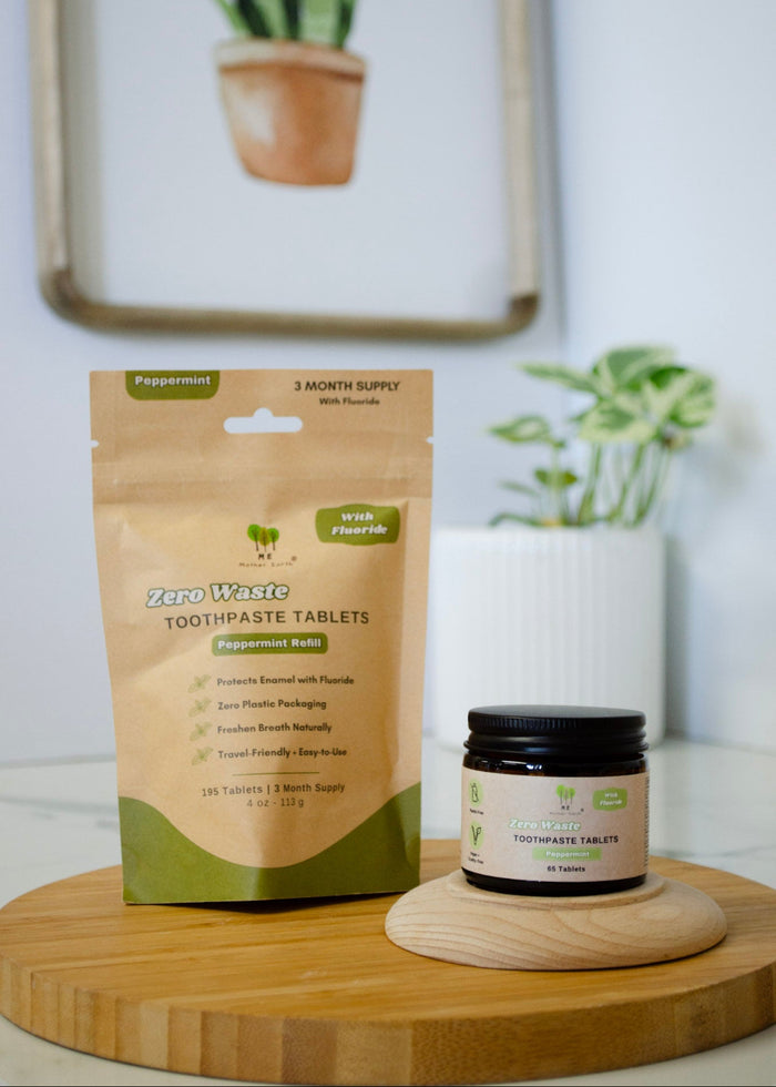Zero Waste toothpaste tablets packaging and jar on a wooden board with plants in the background