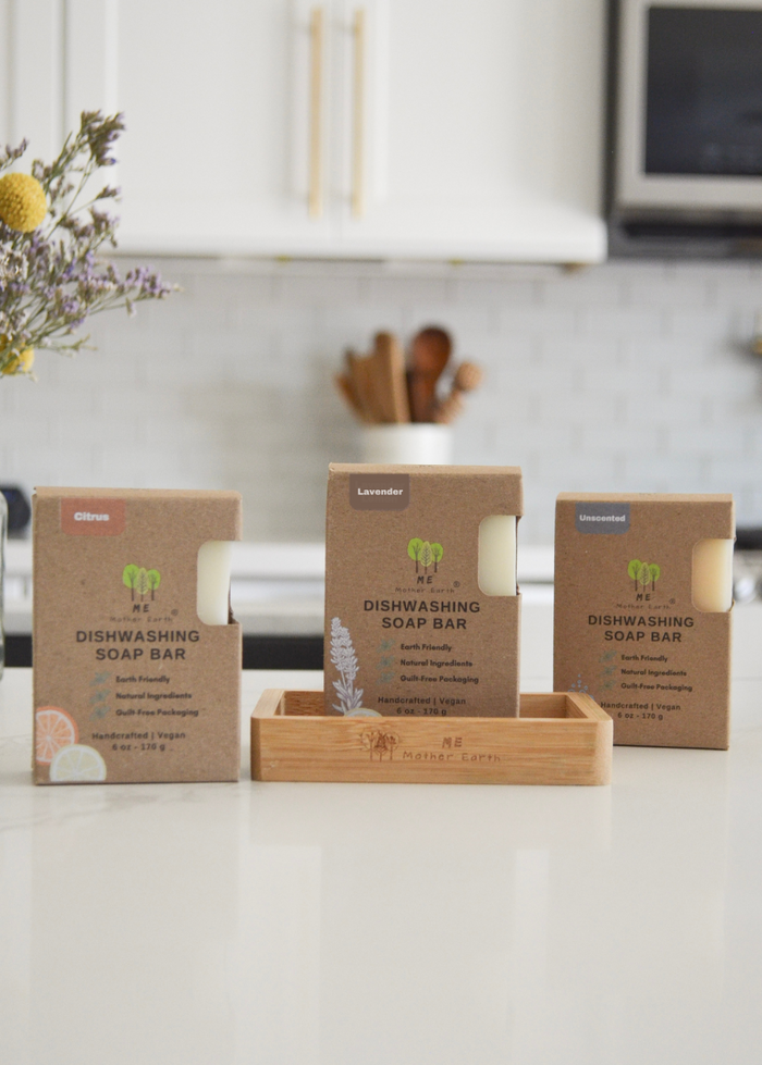 Three boxes of dishwashing soap bars on a kitchen counter with a neutral background.