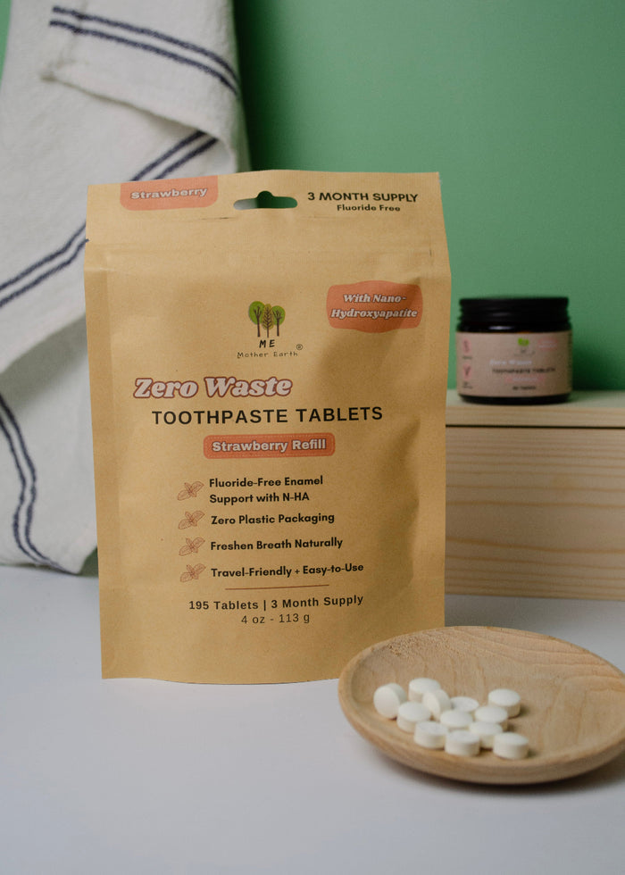 Zero Waste Toothpaste Tablets packaging with tablets on a wooden plate against a green background