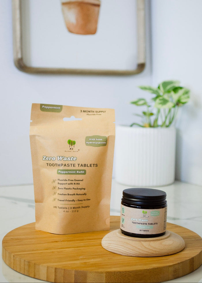 Zero waste toothpaste tablets packaging on a wooden stand with plants in the background